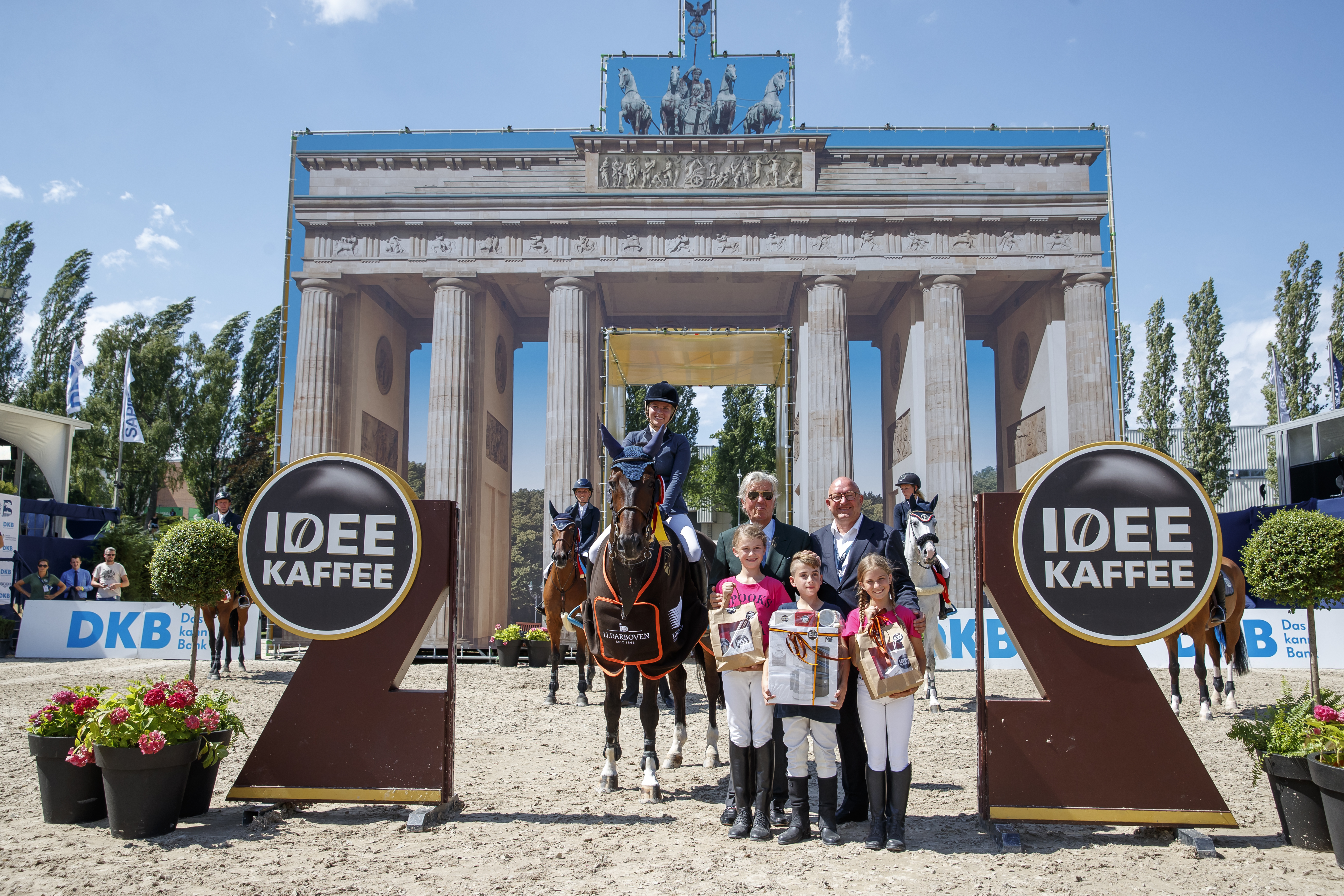 Laureen Budde (GER)/Gosbodino gewinnen den CSI1* IDEE KAFFEE Preis. Es gratulieren Albert Darboven und Veranstalter Volker Wulff. Global Jumping Berlin